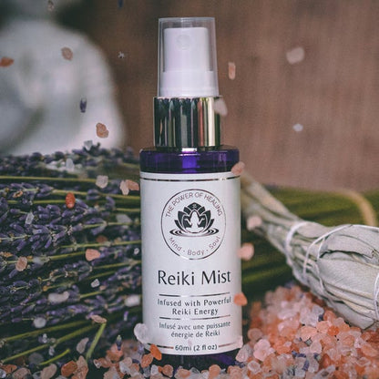 Reiki Mist bottle with lavender and crystals on a wooden surface